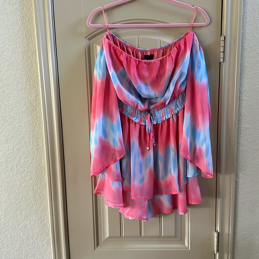 Flowy romper with butterfly sleeves.